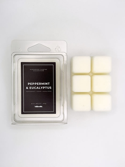 Peppermint & Eucalyptus 85g wax melt clamshell placed beside six wax cubes from the Hellomelts Winter Collection