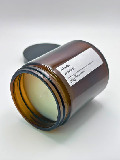 Pumpkin Pie autumn scented candle by Hellomelts lying on its side with the wick facing forward, part of the Autumn Collection
