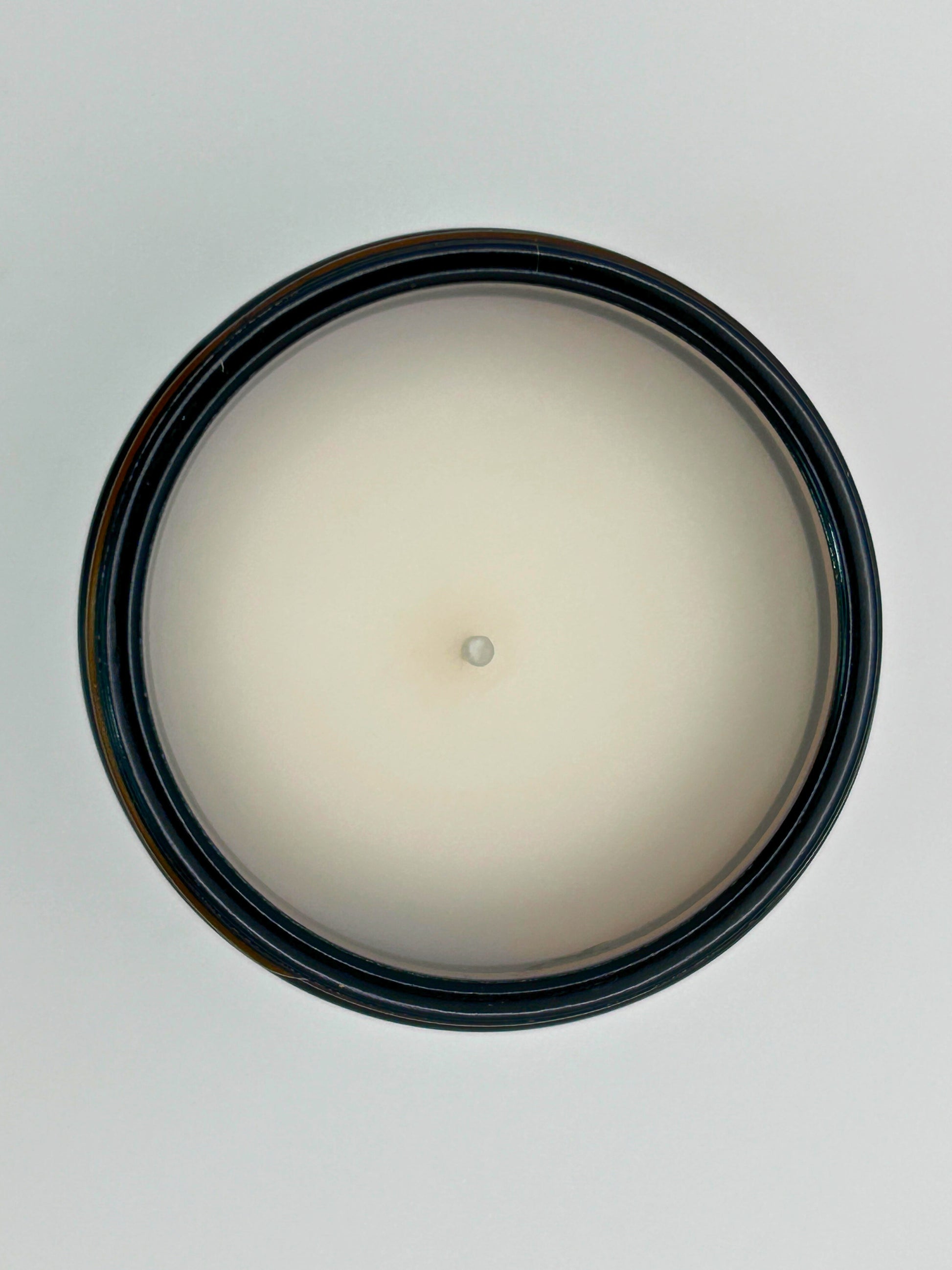 Top-down view of Pumpkin Pie autumn candle by Hellomelts, highlighting the wick and hand-poured wax in an amber jar, part of the Autumn Collection