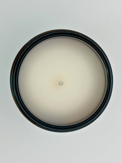 Top-down view of Pumpkin Pie autumn candle by Hellomelts, highlighting the wick and hand-poured wax in an amber jar, part of the Autumn Collection
