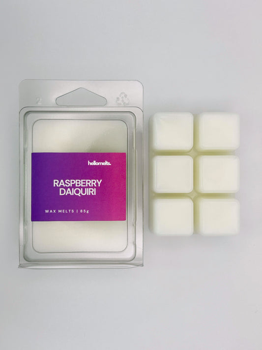 Raspberry Daiquiri 85g wax melt bar by Hellomelts pictured beside its clamshell packaging, part of the Summer Collection