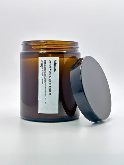 Front view of Sandalwood & Black Pepper autumn scented candle by Hellomelts with the lid placed beside it, part of the Autumn Collection