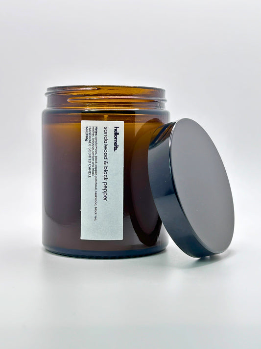 Front view of Sandalwood & Black Pepper autumn scented candle by Hellomelts with the lid placed beside it, part of the Autumn Collection