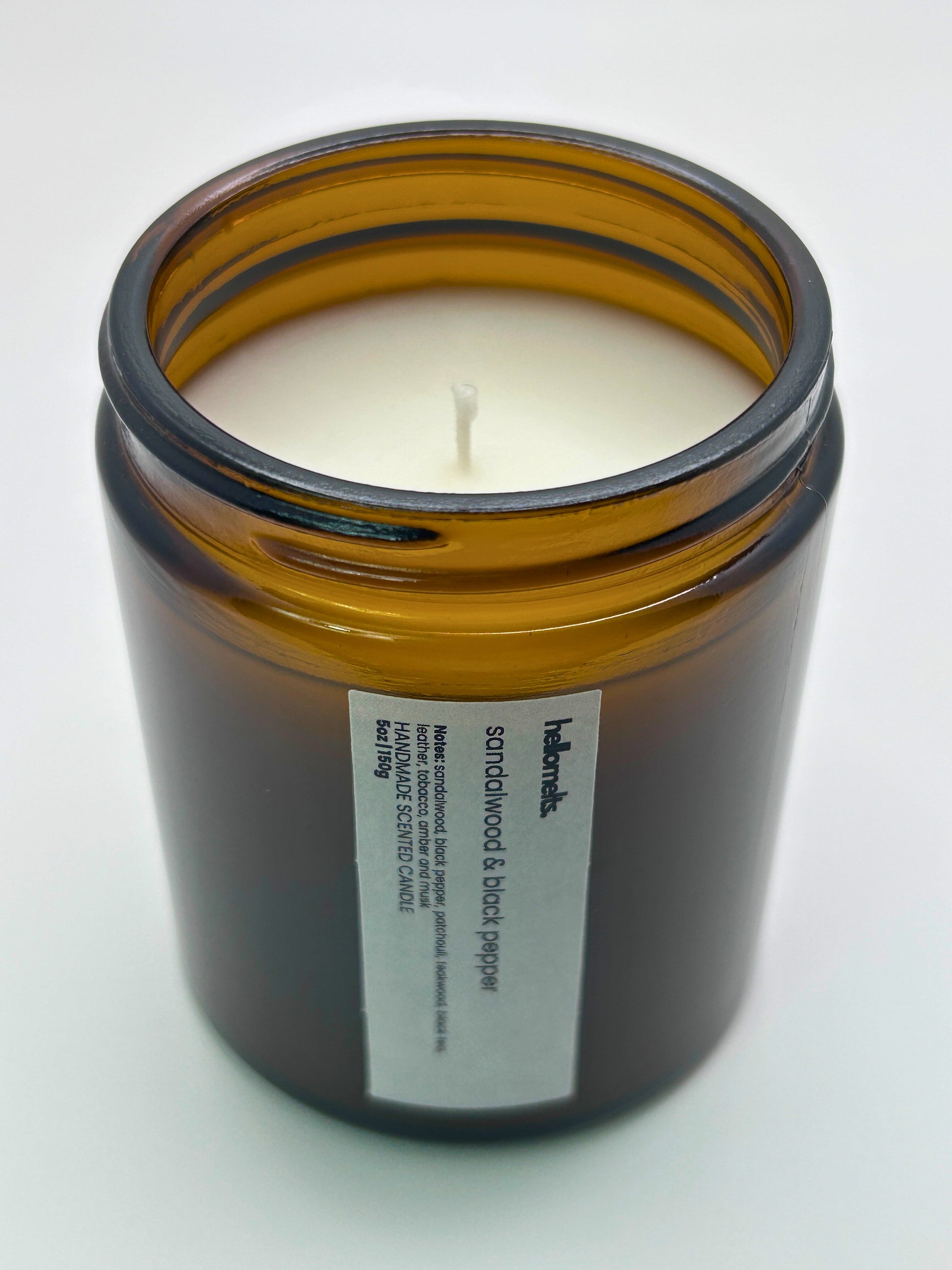 Angled top-down view of Sandalwood & Black Pepper autumn candle by Hellomelts, highlighting the wick and hand-poured wax, part of the Autumn Collection