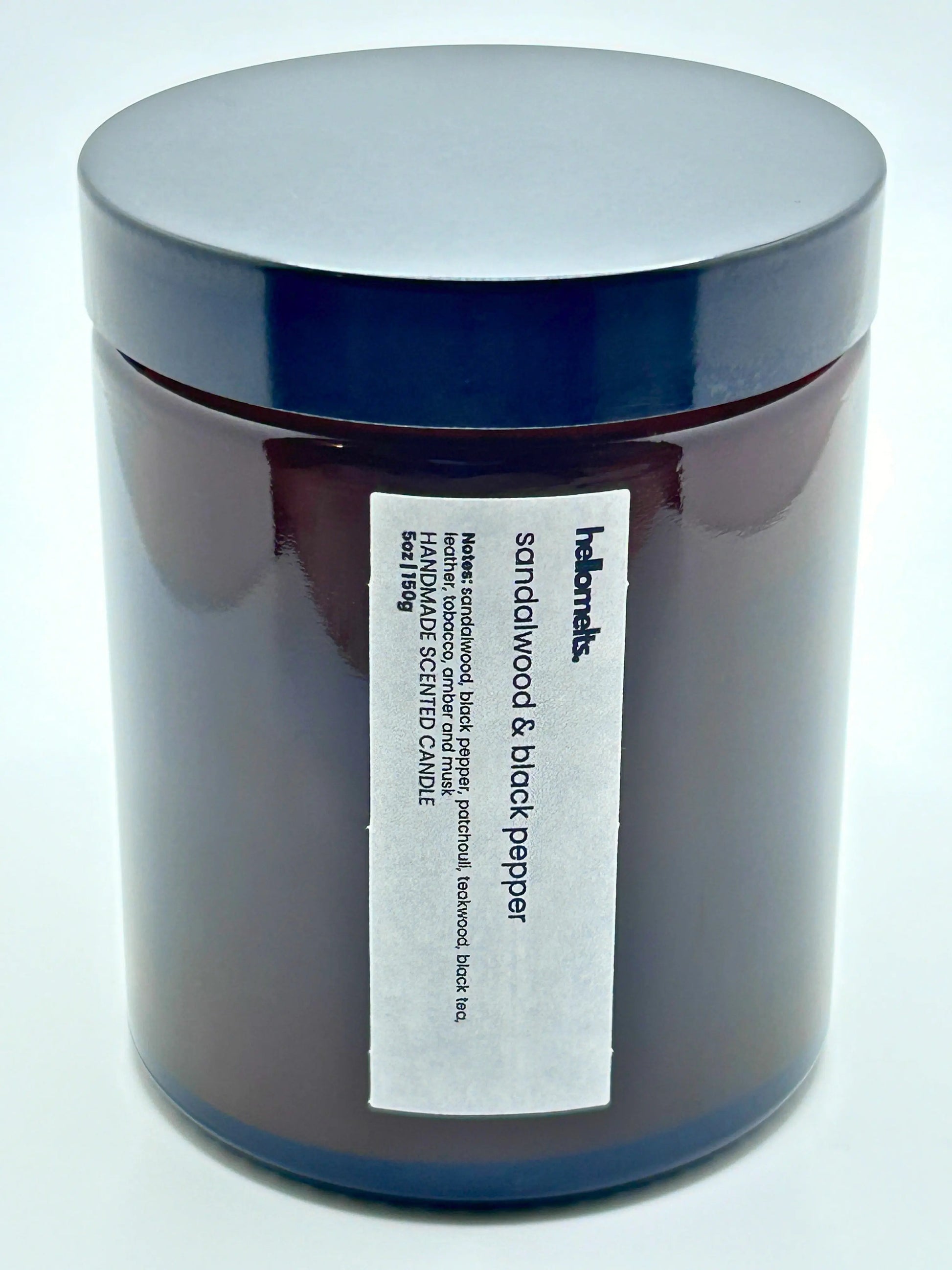 Close-up front view of Sandalwood & Black Pepper candle by Hellomelts  with the lid on, part of the autumn collection.