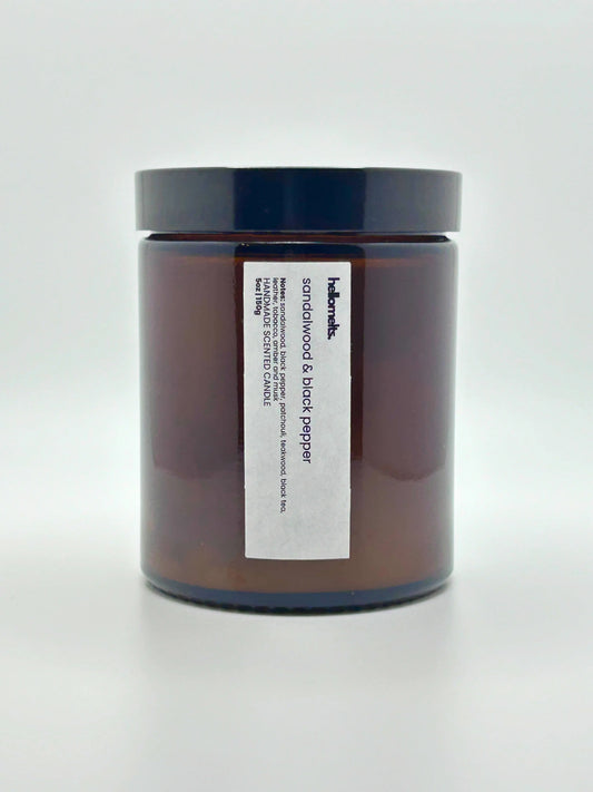 Front view of Sandalwood & Black Pepper scented candle by Hellomelts with the lid on, part of the autumn collection.