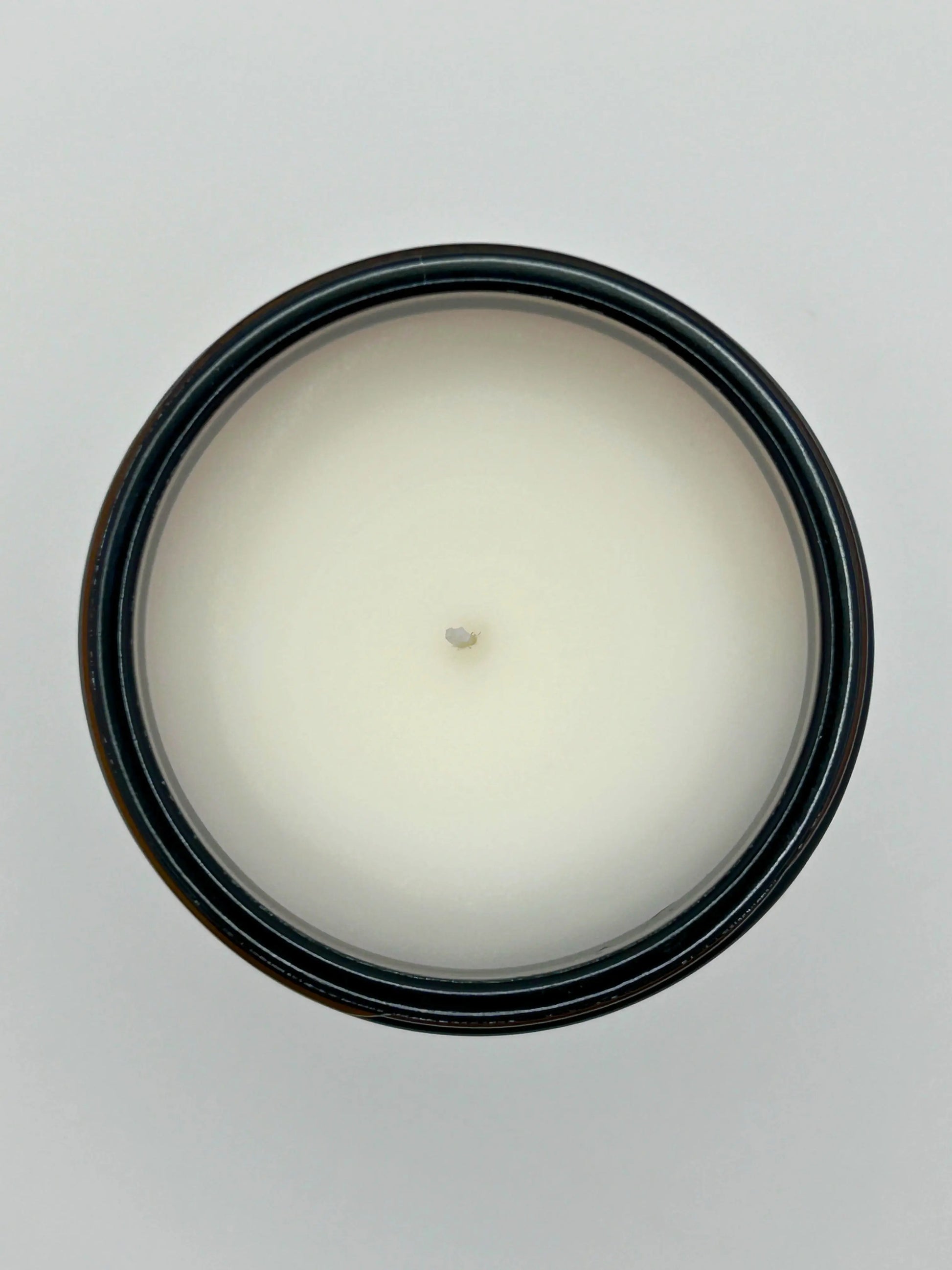 Top view of Sandalwood & Black Pepper candle from Hellomelts, showing the hand-poured wax in an amber jar from the autumn collection.
