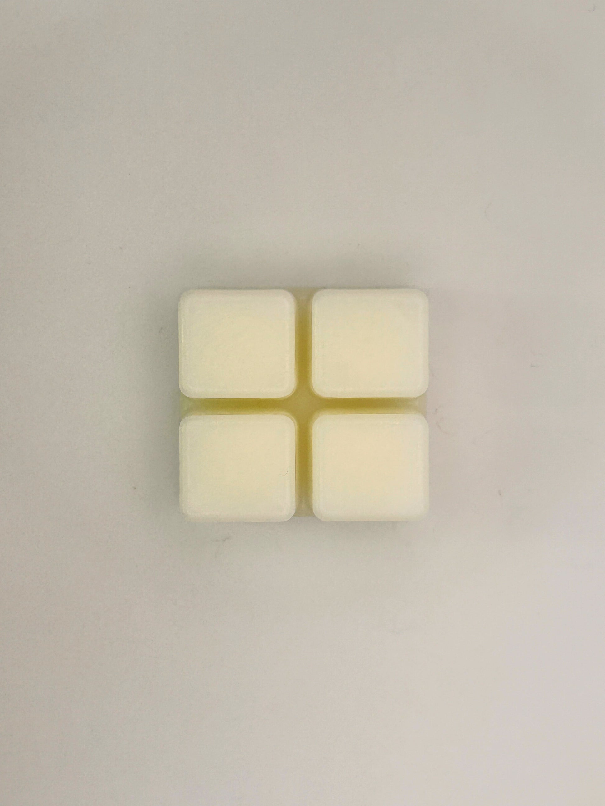 Flatlay of Sandalwood & Black Pepper 60g wax melt bar on a light background from the Hellomelts Autumn Collection