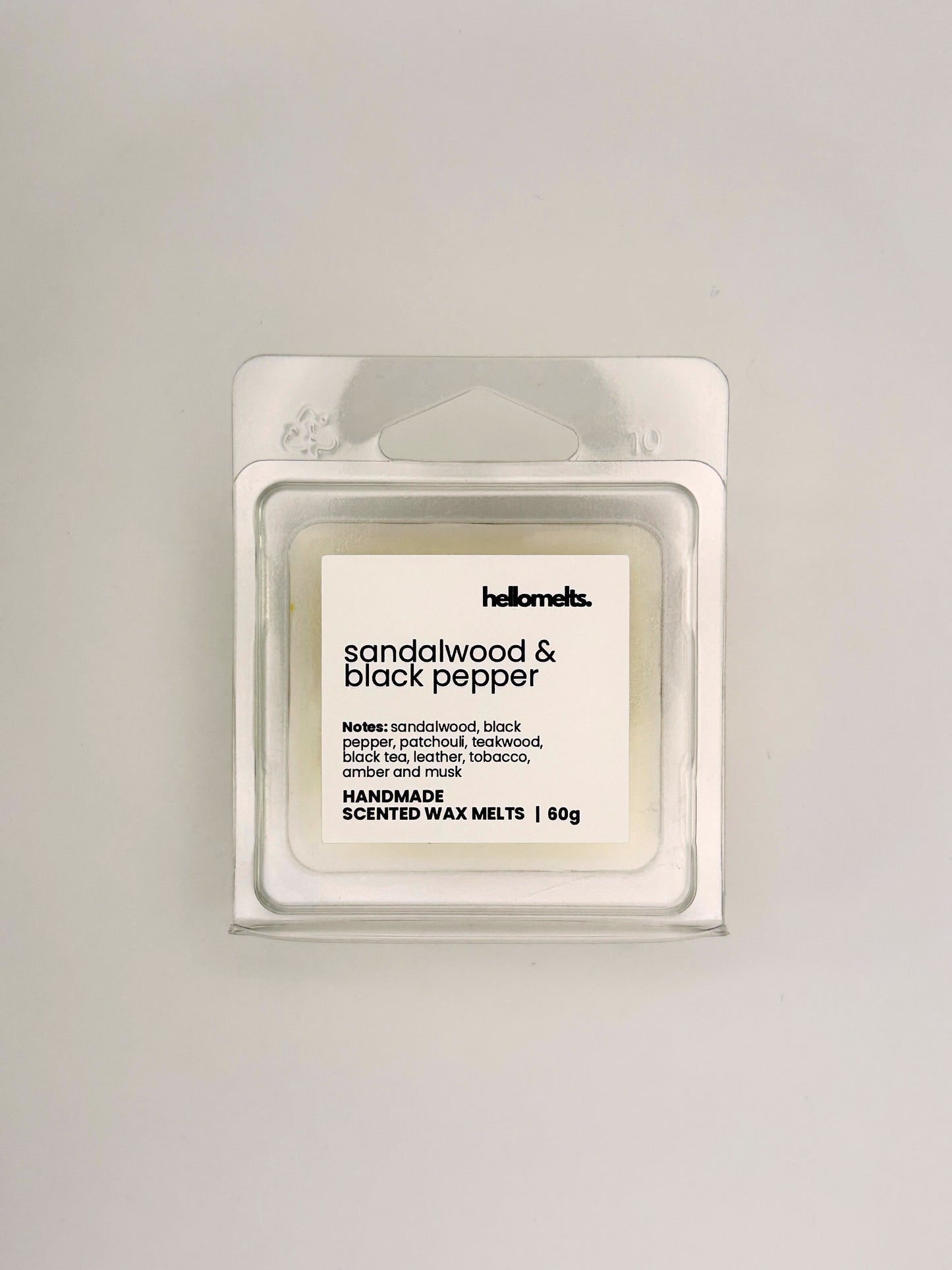 Front view of Sandalwood & Black Pepper 60g wax melt in clear clamshell packaging from the Hellomelts Autumn Collection