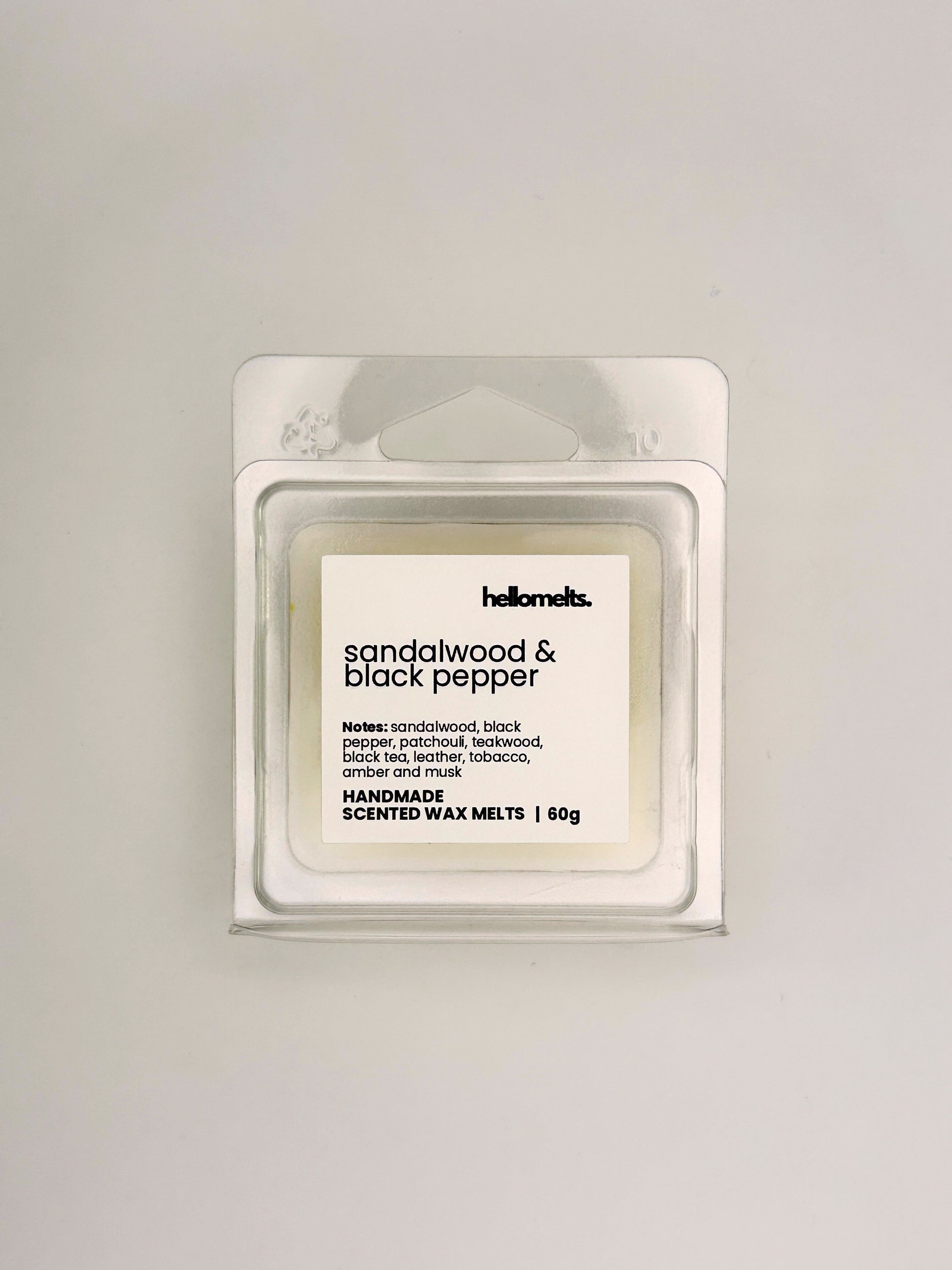 Front view of Sandalwood & Black Pepper 60g wax melt in clear clamshell packaging from the Hellomelts Autumn Collection