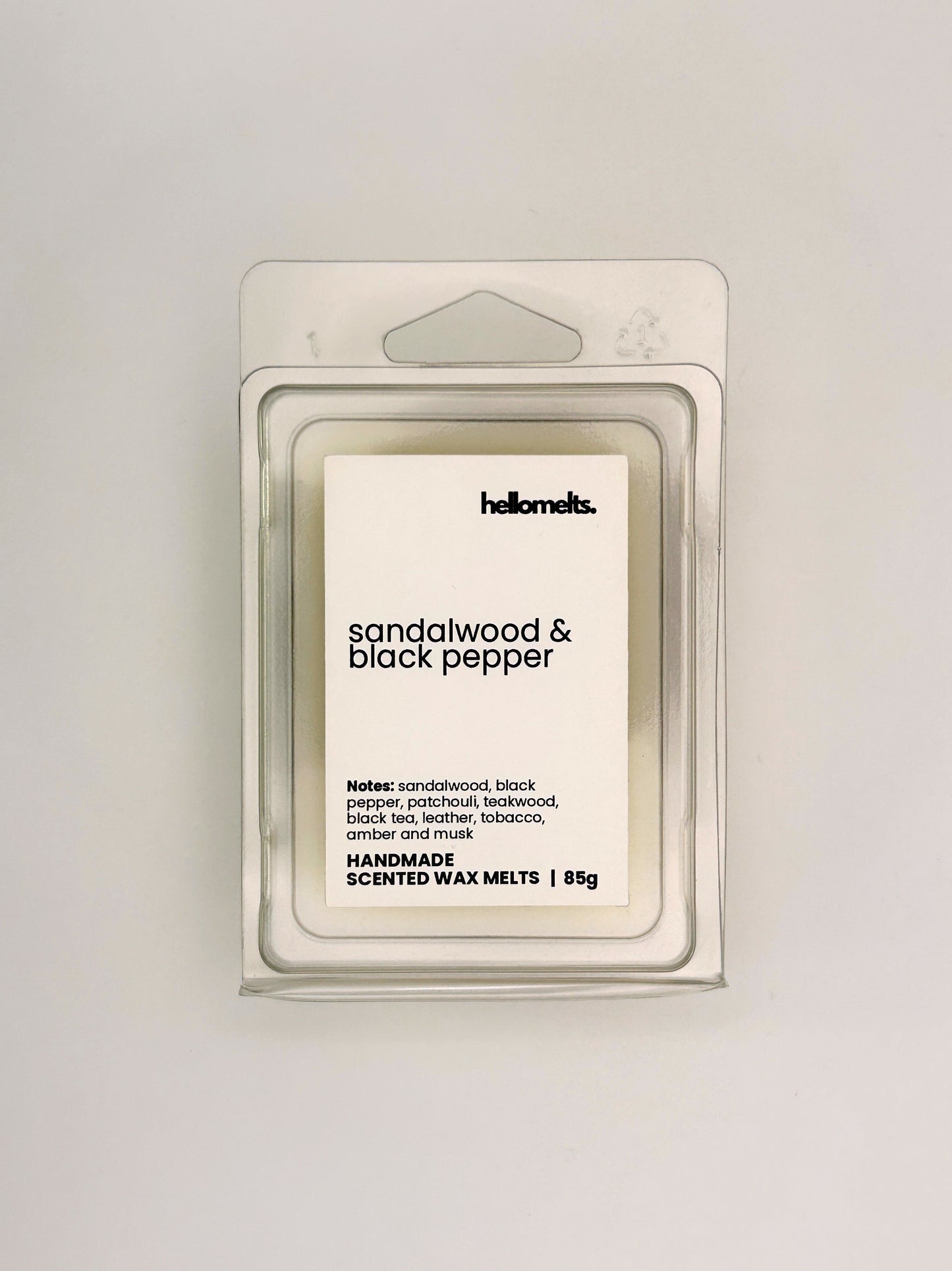 Front view of Sandalwood & Black Pepper 85g wax melt in clear clamshell packaging from the Hellomelts Autumn Collection