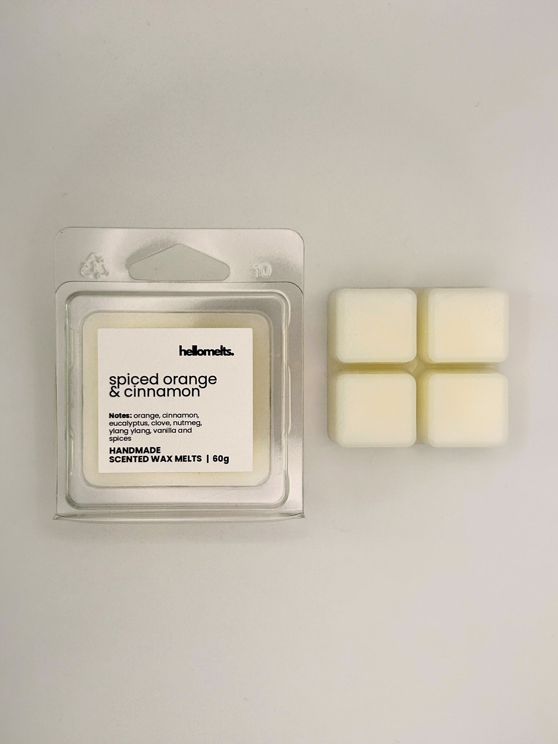 Spiced Orange & Cinnamon 60g wax melt bar displayed beside its clear clamshell packaging from the Hellomelts Autumn Collection