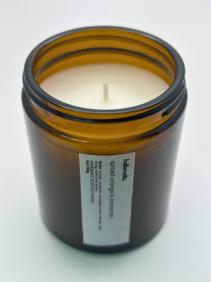Angled top-down view of Spiced Orange & Cinnamon autumn candle by Hellomelts, highlighting the wick and hand-poured wax, part of the Autumn Collection