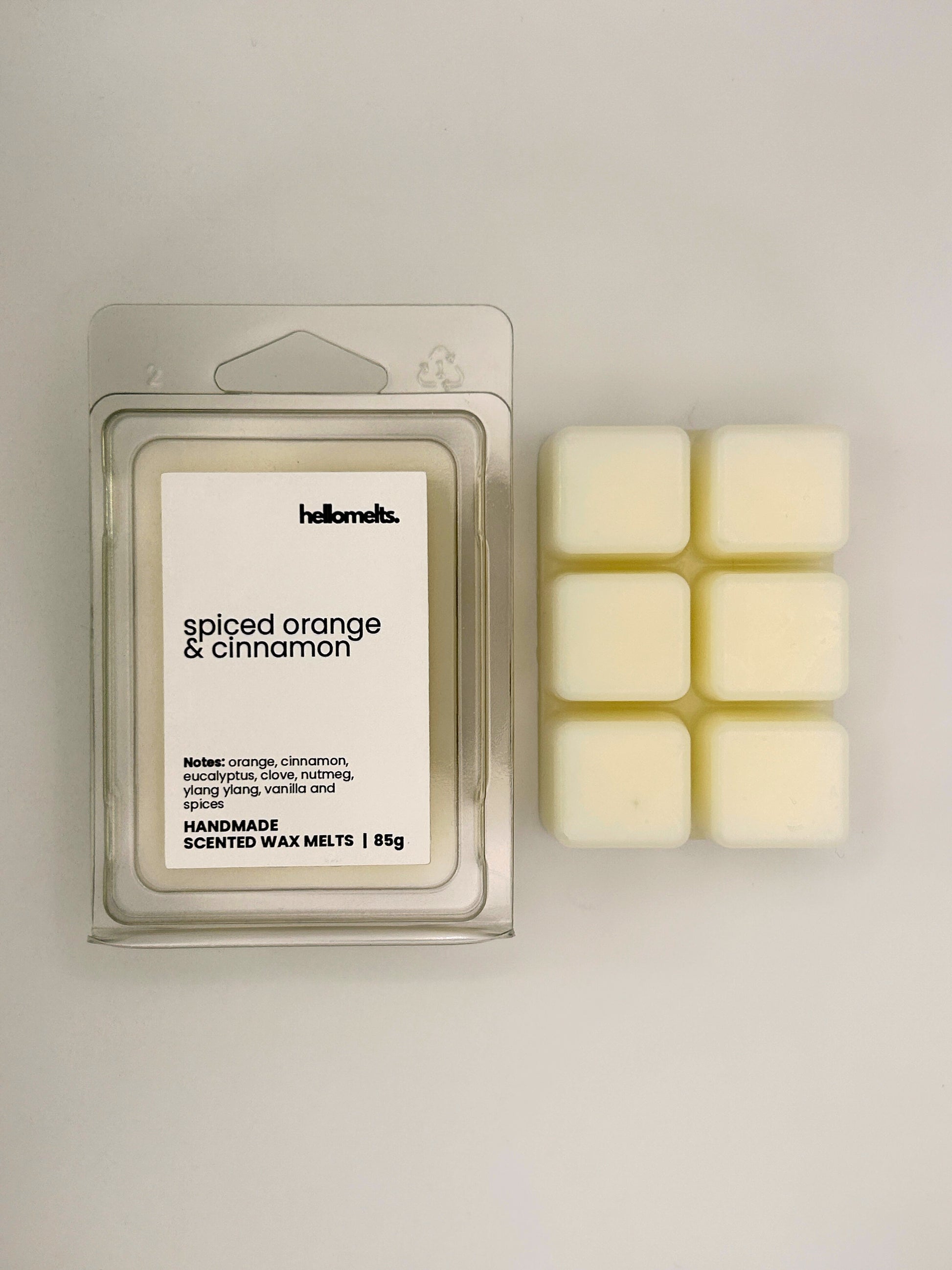 Spiced Orange & Cinnamon 85g wax melt bar displayed beside its clear clamshell packaging from the Hellomelts Autumn Collection