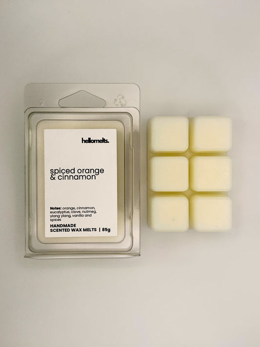 Spiced Orange & Cinnamon 85g wax melt bar displayed beside its clear clamshell packaging from the Hellomelts Autumn Collection