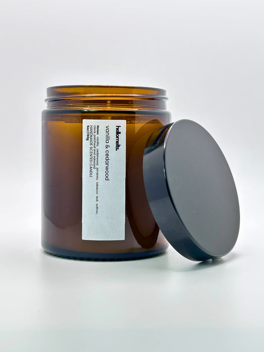 Front view of Vanilla & Cedarwood autumn scented candle by Hellomelts with the lid placed beside it, part of the Autumn Collection