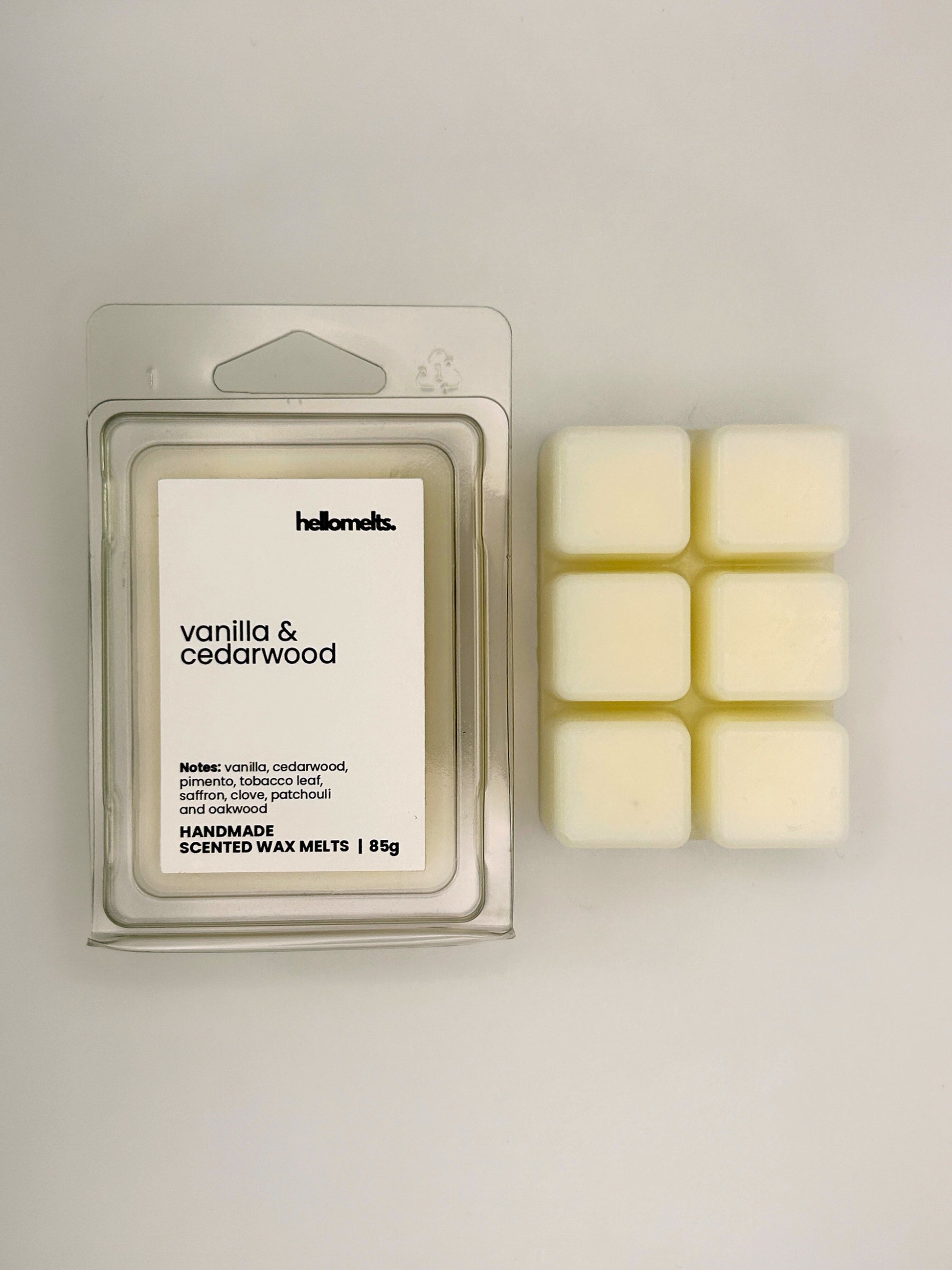 Vanilla & Cedarwood 85g wax melt bar displayed beside its clear clamshell packaging from the Hellomelts Autumn Collection