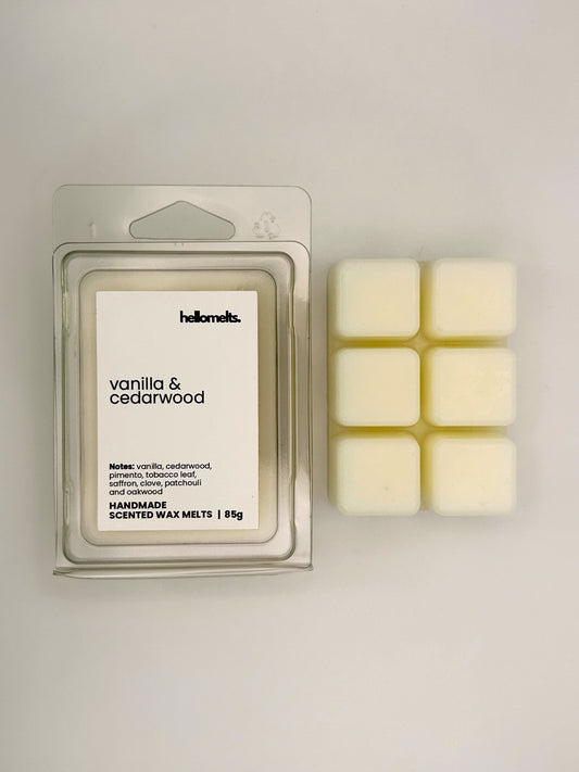 Vanilla & Cedarwood 85g wax melt bar displayed beside its clear clamshell packaging from the Hellomelts Autumn Collection