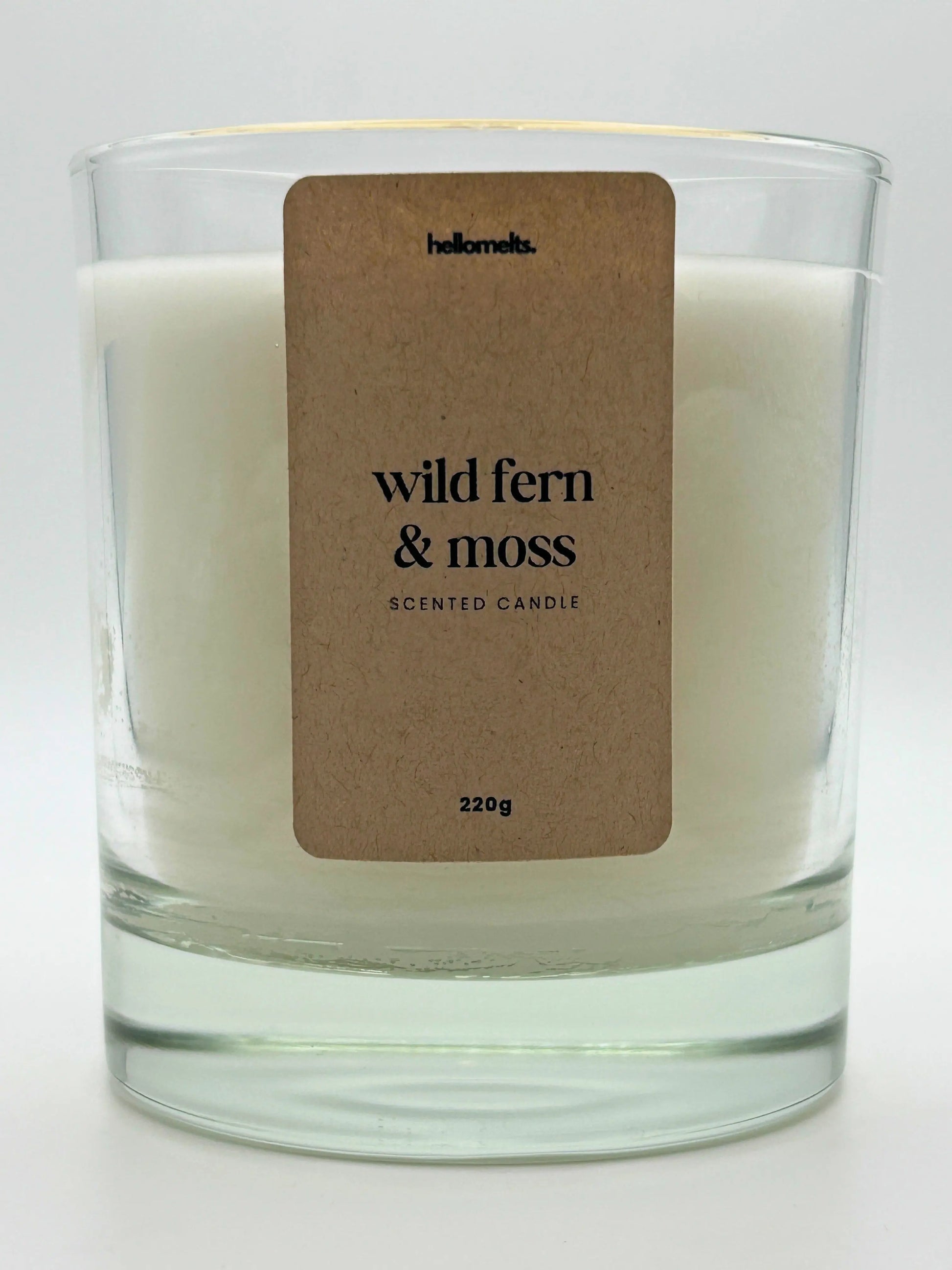 Close-up of the Wild Fern & Moss candle label showing scent name and weight, a handcrafted candle by Hellomelts for the Spring Collection.