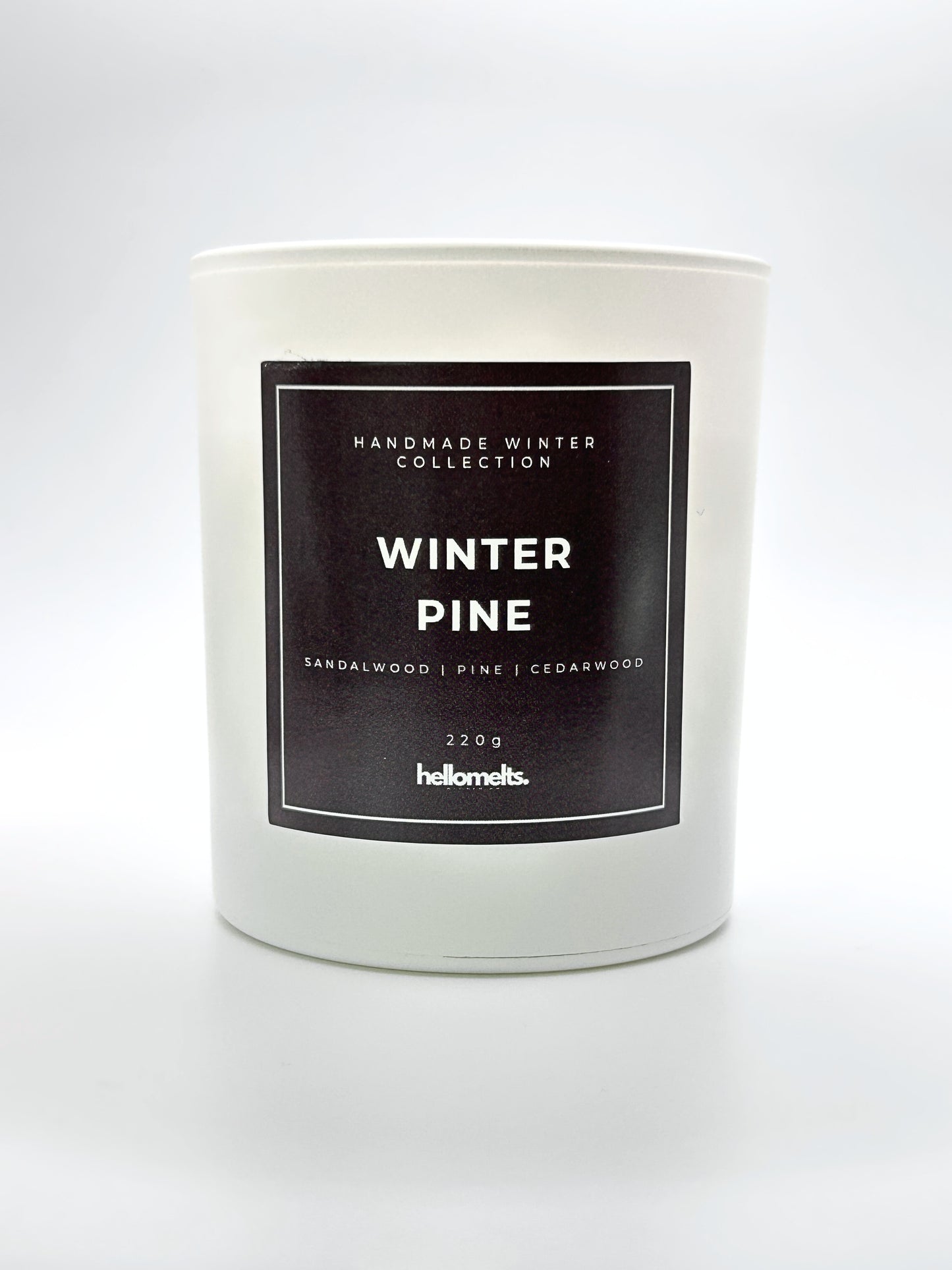 Winter Pine 220g candle front-facing studio shot without the lid, showing the clean white jar and label from the Hellomelts Winter Collection