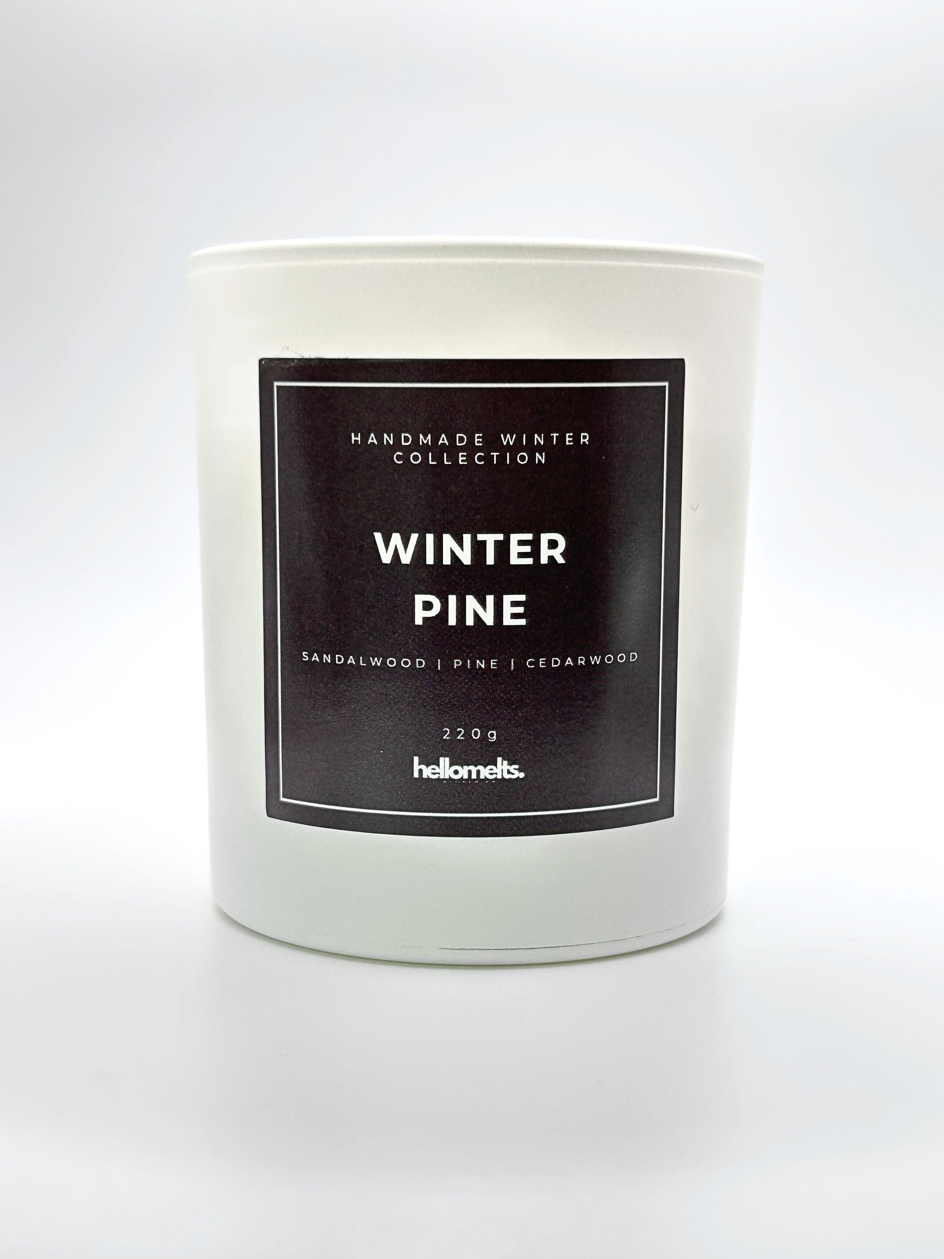 Winter Pine 220g candle front-facing studio shot without the lid, showing the clean white jar and label from the Hellomelts Winter Collection