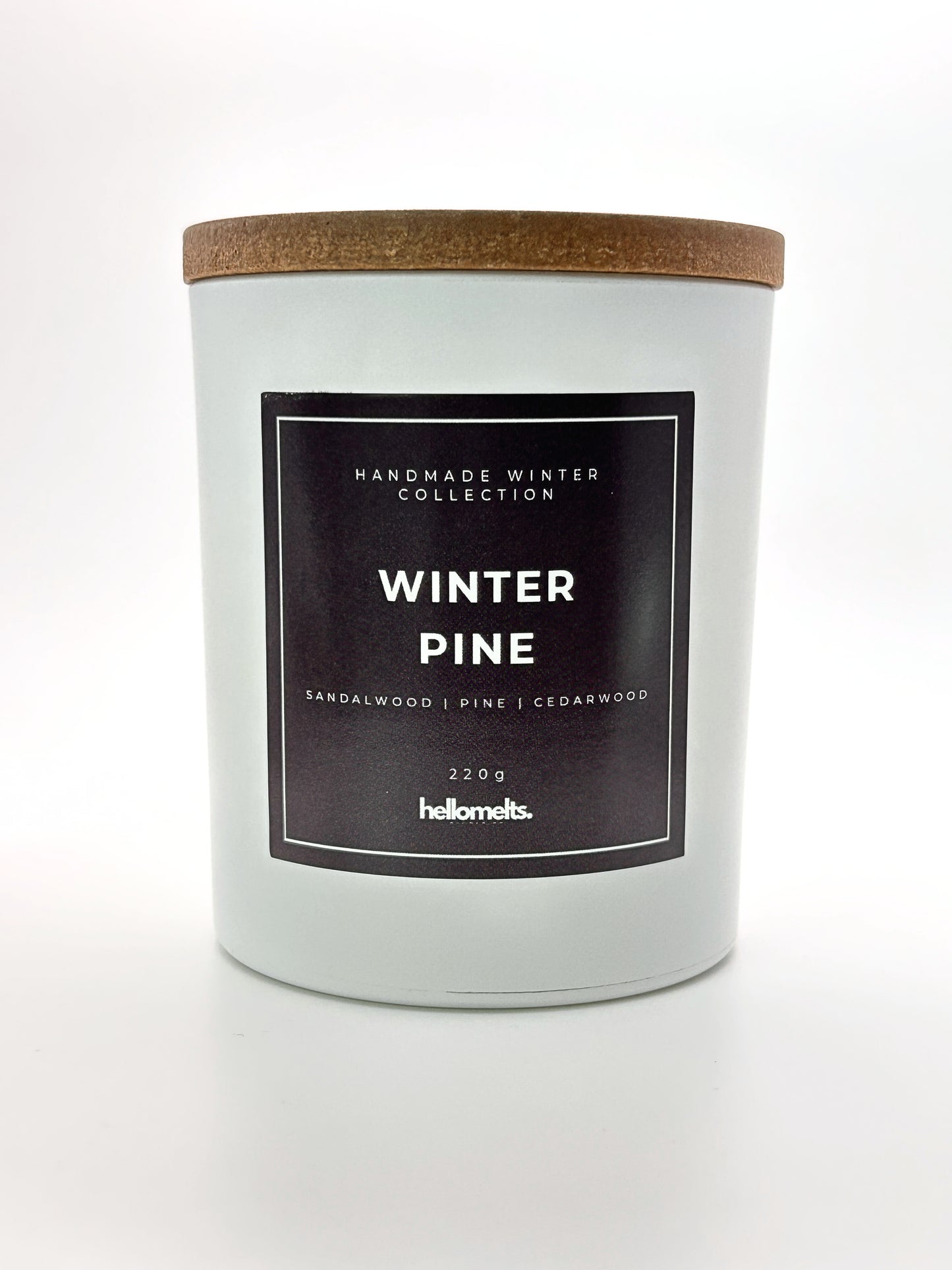 Winter Pine 220g candle front-facing studio shot with wooden lid on, part of the Hellomelts Winter Collection