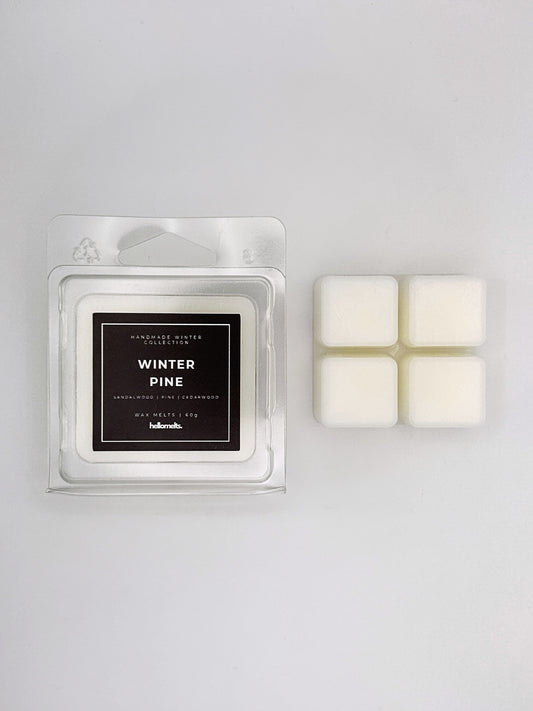Winter Pine 60g wax melt clamshell placed beside four wax cubes, part of the Hellomelts Winter Collection