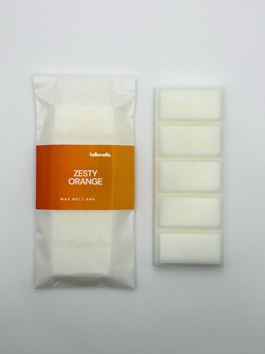 Zesty Orange 50g wax melt bar by Hellomelts, shown unwrapped beside the five-bar segmented wax melt.