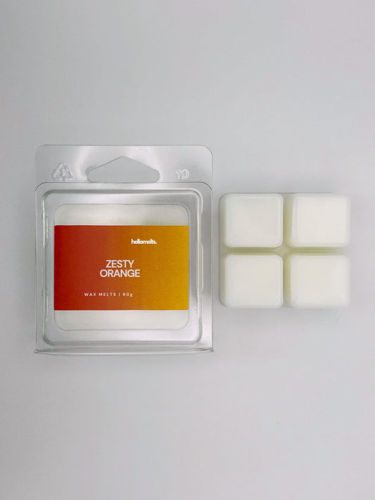 Zesty Orange 60g wax melt bar by Hellomelts pictured beside its clamshell packaging, part of the Summer Collection