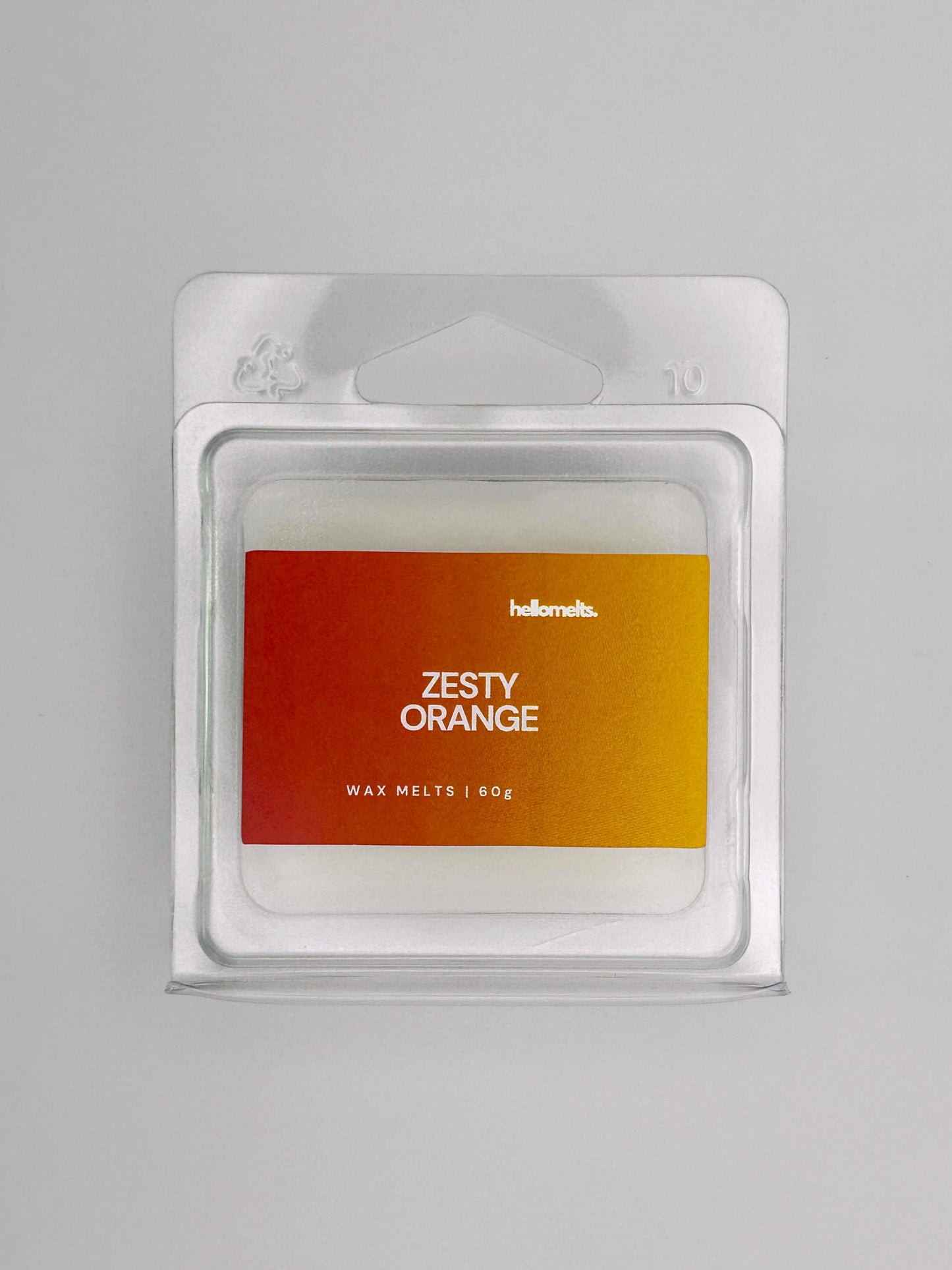 Close-up front view of Zesty Orange 60g wax melt bar by Hellomelts, showing wax texture and vibrant label design
