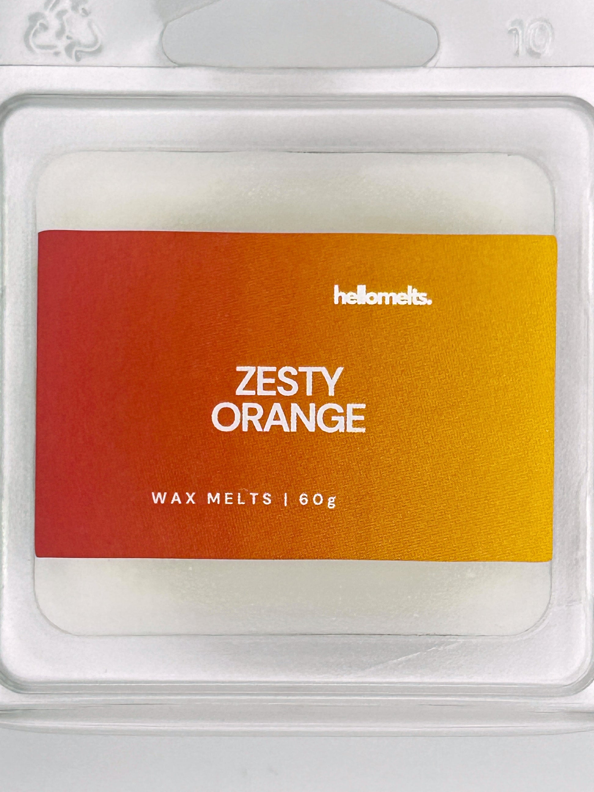 Close-up of the Zesty Orange 60g wax melt label, showing detailed branding and refreshing citrus scent design from Hellomelts